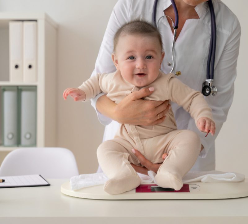 doctor-holding-cute-baby-front-view