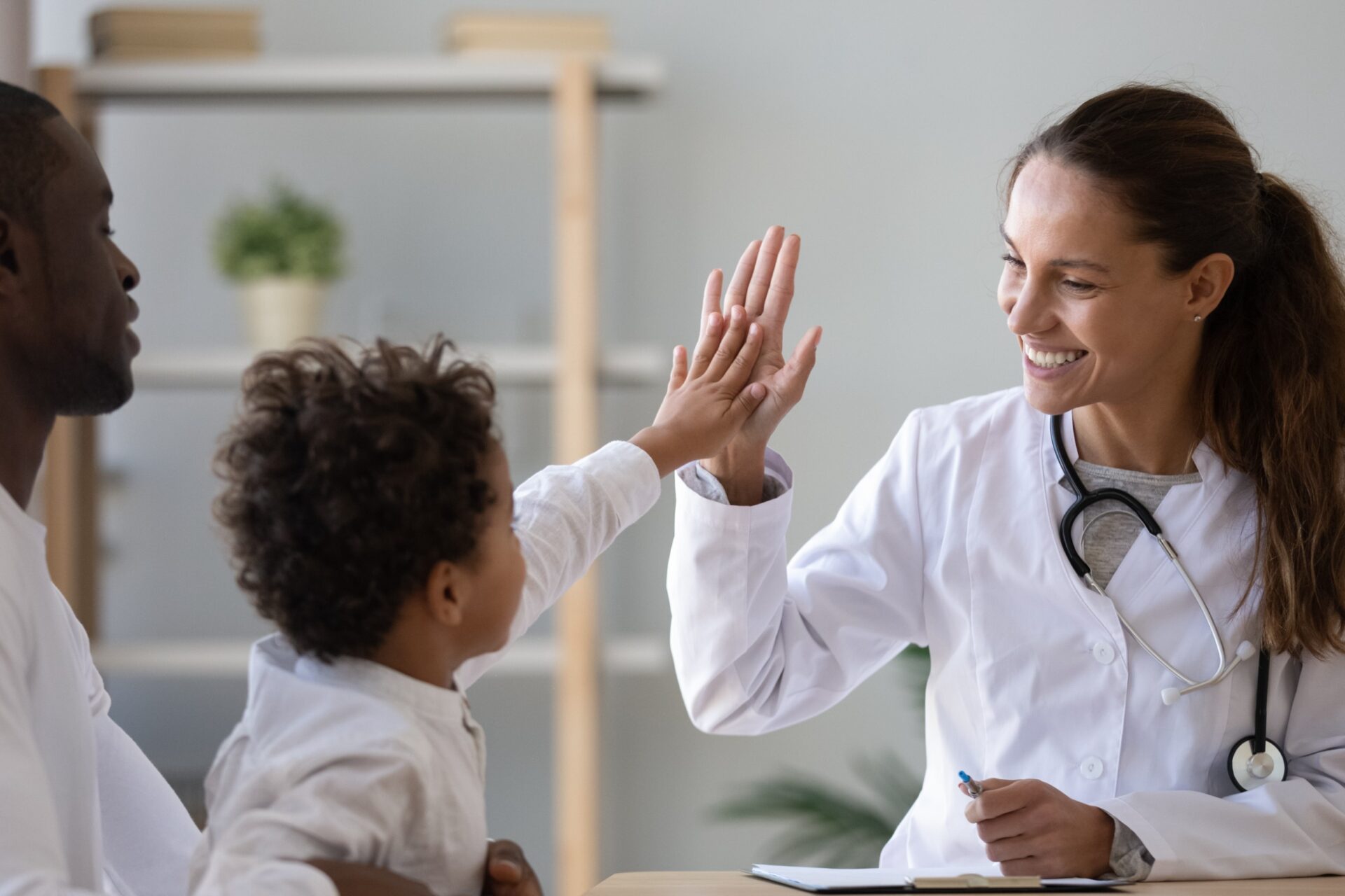 Pediatrician with toddler and her mom