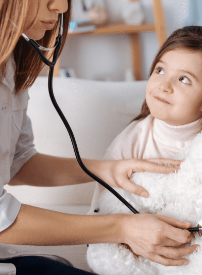 a young girl is being examined by a doctor